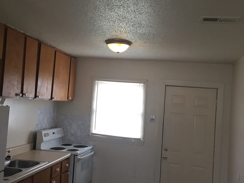 spacious kitchen with refrigerator and oven