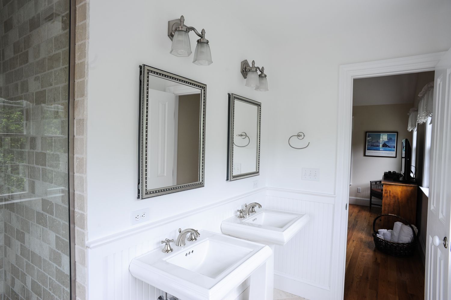  Master bathroom with Kohler pedestal sinks, custom tumbled marble tile, and frameless glass shower
