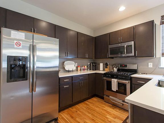 Fully equipped kitchen with stainless steel appliances and gas stovetop. Plenty of storage.