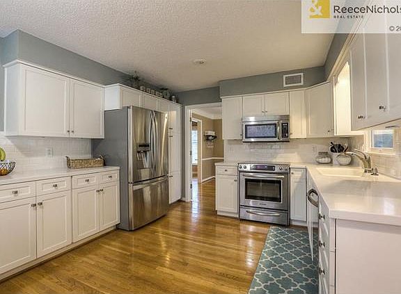 Light, bright and fresh! Hardwood floors and SS appliances in kitchen.