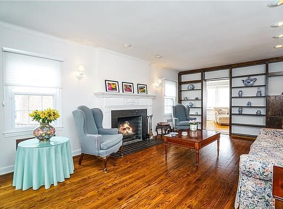 Spacious Living Room with a beautiful carved decorative fireplace.