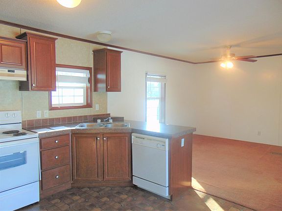 To the left of front room, is this wonderful kitchen with plenty of cupboards and a dishwasher. Notice the new wooden blinds on the windows.
