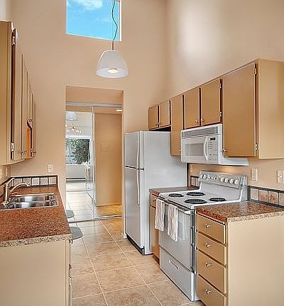 Kitchen with vaulted ceilings and tall picture window