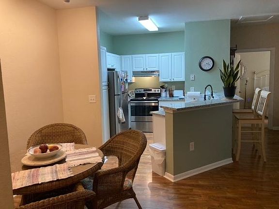 Dining area and updated kitchen with stainless steel appliances and sink, new granite counter tops and new faucet.