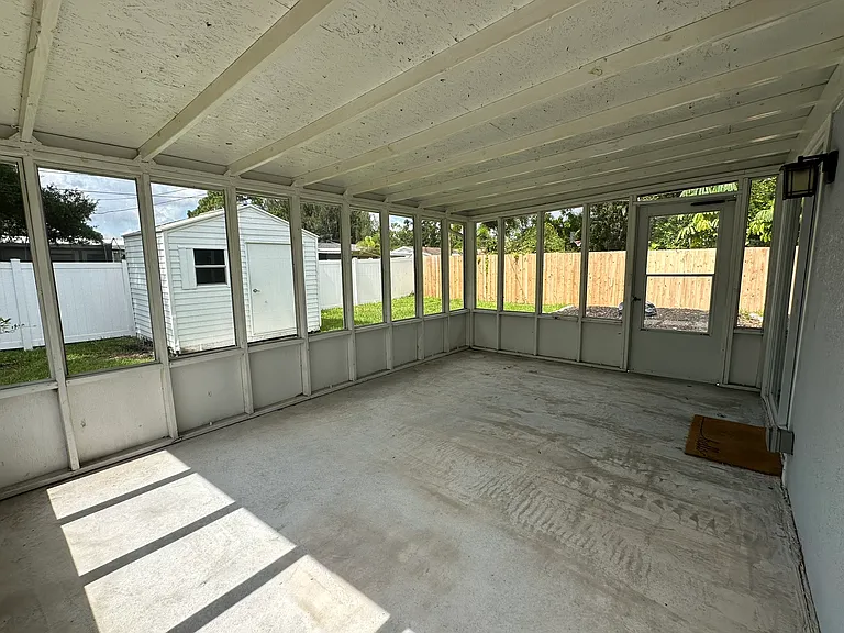 large screened in back porch; the wood was freshly painted after taking this photo