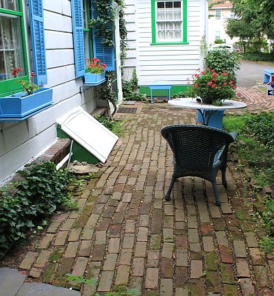 Brick Pathways leads to Fenced Backyard