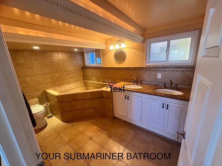 The 'submariner level' bathroom off of the middle room. A wall of cabinets is to the right, behind the door.