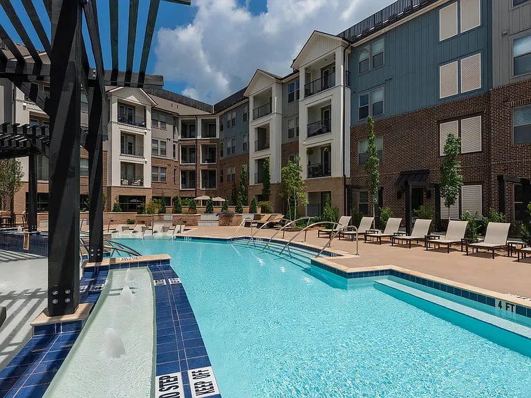 Community Pool Area Featuring Lounge Deck and In-Pool Sun Shelf