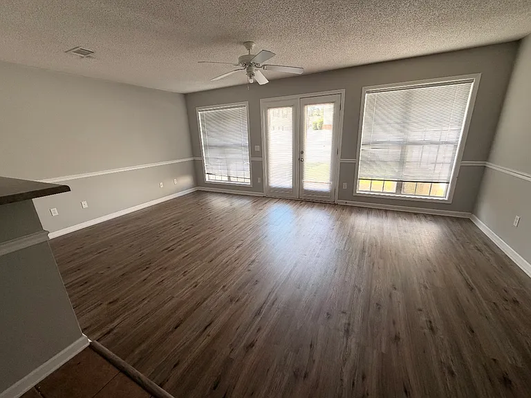 Living area with double-french doors leading to outside patio; LVP flooring
