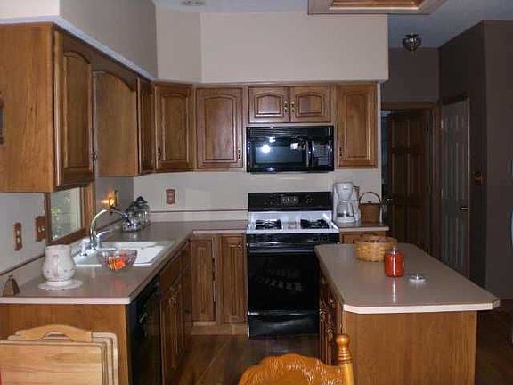 Spacious kitchen with hardwood floors.