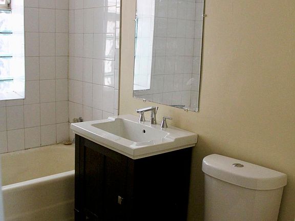 Newly remodeled bath with Honey Onyx stone floor