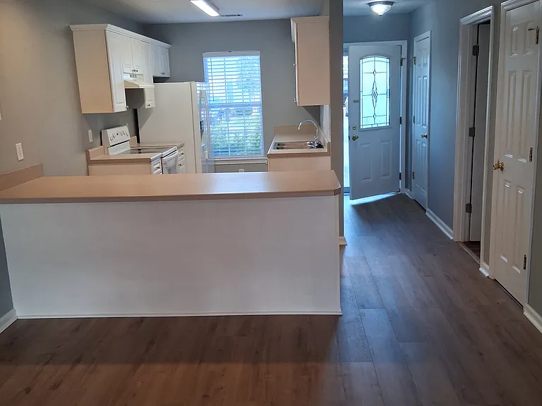 Looking into kitchen and front door from living room