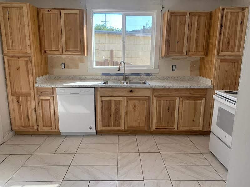 head on view of the upgraded kitchen with new tile flooring, hickory cabinets, sink, faucet, countertop, dish washer and disposal! 
View from the family room!