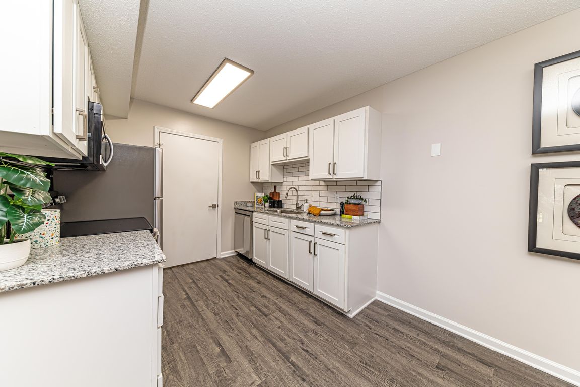 Kitchen with granite counters and modern cabinetry