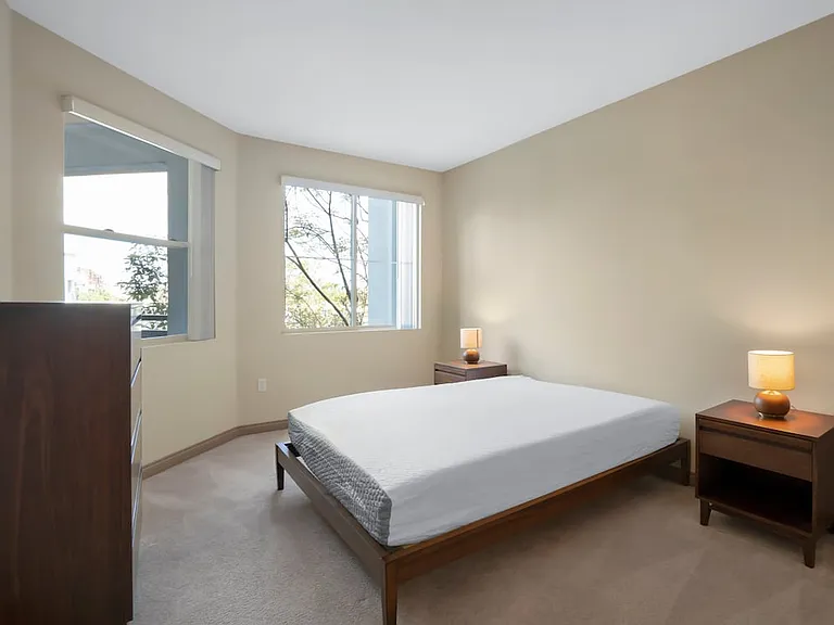Furnished+ apartment homes feature queen bed with mattress, dresser, nightstands, and lamps (Representative Image exact items and style of furnishings may vary)
