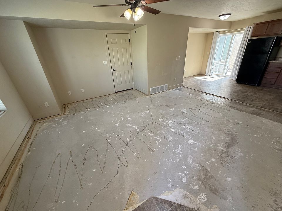 View of main floor from entry, showing door to garage and sliding door to back