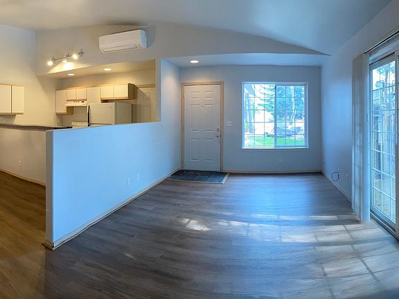 Divided open living room, dining room and kitchen.