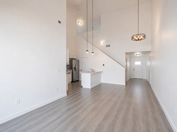 Living room to kitchen and entryway.