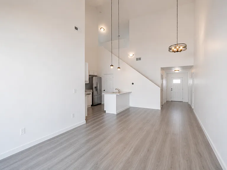 Living room to kitchen and entryway.