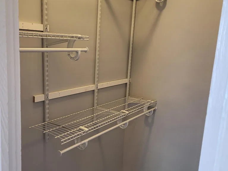 Walk in closet with new clothes organizer