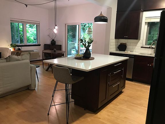 Generous kitchen island with deep cabinets and drawers for additional storage and seating.