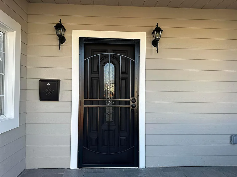 The main entrance has a steel security door installed to provide additional safety measures.