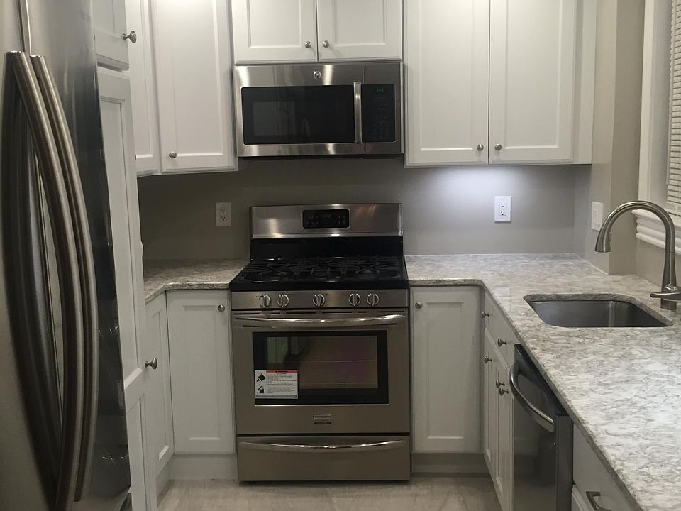 Fully renovated kitchen- quartz countertops and stainless steel appliances (dishwasher, stove/oven, microwave, refrigerator)