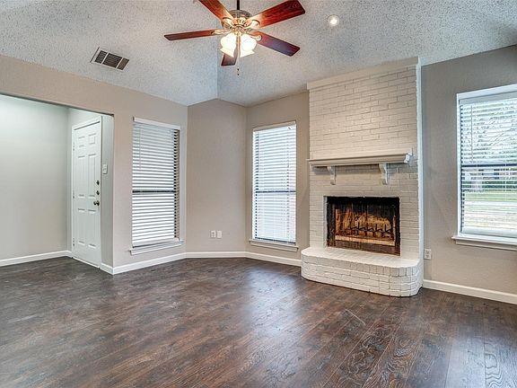 Living area with wood burning fireplace.