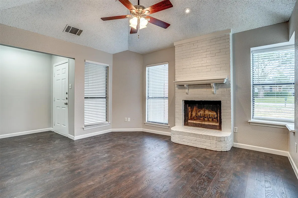 Living area with wood burning fireplace. - 2124 Artherfield Dr