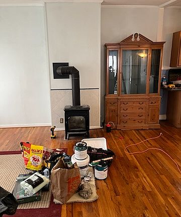 living room with cast iron gas fireplace and china cabinet
