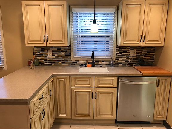 Updated kitchen with solid surface countertops and soft-close drawers.