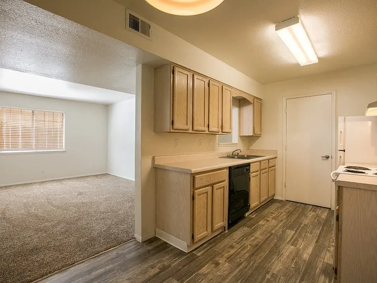 Open kitchen with rich flooring