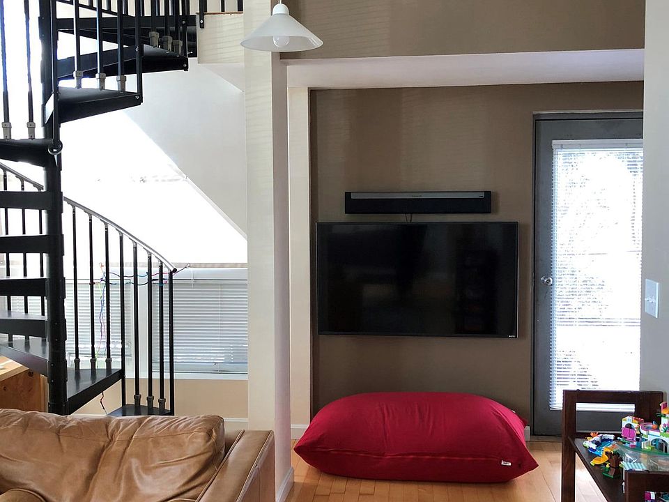 Open living area with spiral staircase to loft
