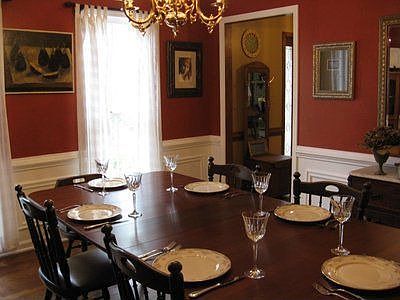 Large diningroom with custom walls and hardwood floors
