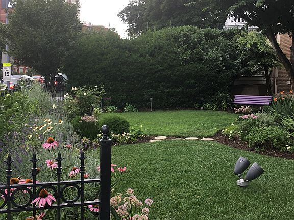Well-kept lawn and seating in front of building