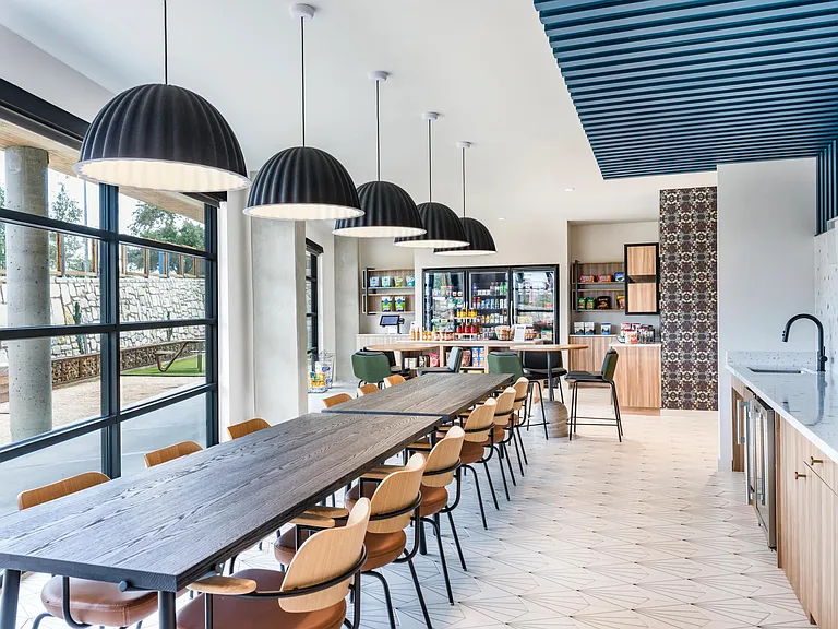 Boost your productivity in style at Modera EaDo's coworking space, featuring additional seating options for collaborative work.