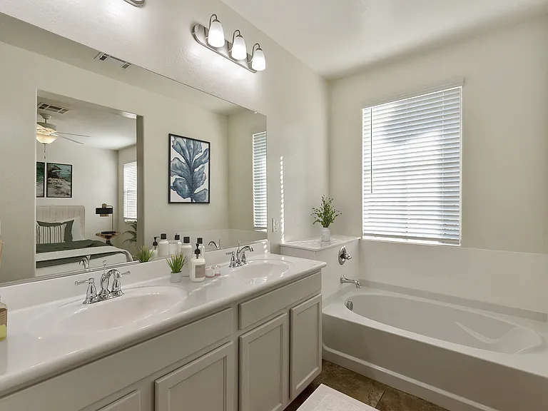 Dual sink vanity in master bathroom with soaking tub
