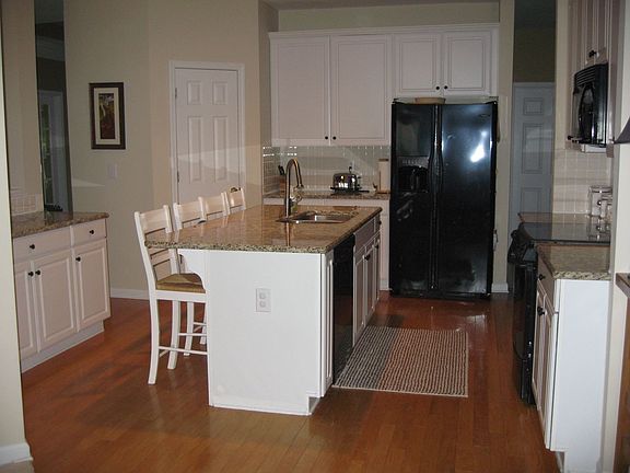 Large Open Kitchen with Slab Granite Counters
