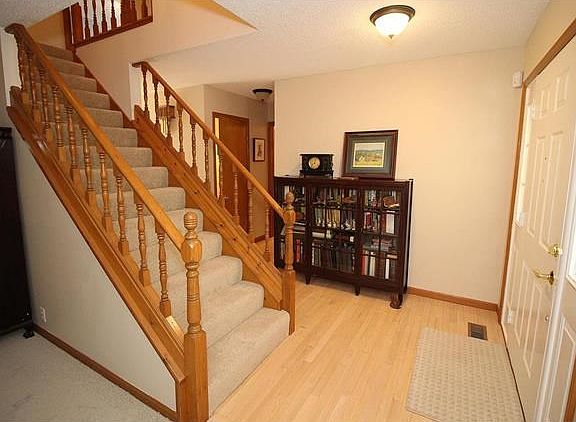 Foyer leads to half bath, main floor laundry and garage.