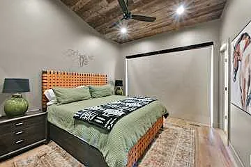 Master bedroom with king sized bed, private bathroom, and French doors to access the deck with a private hot tub and gas fire pit.