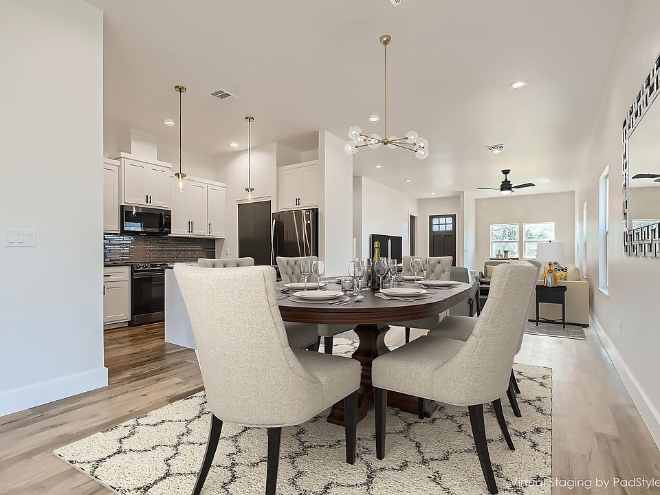 Open kitchen, dining and living room area gives it a nice spacious feel. (Virtual staging)
