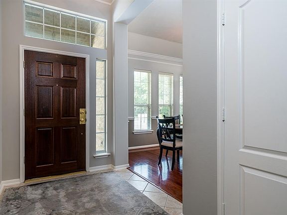 An entryway that is light and bright is very welcoming! Natural light flows into the space from the transom windows and from the formal living space as well!