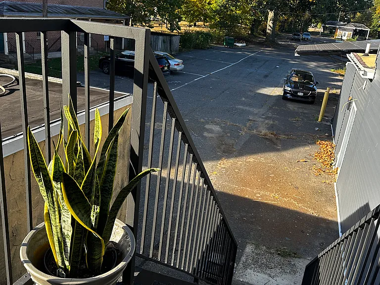 Rear access with back stairs, private landing, and connecting walkway.