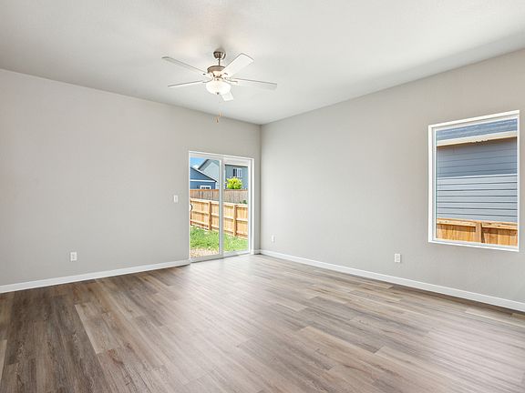 The family room is spacious with a ceiling fan.