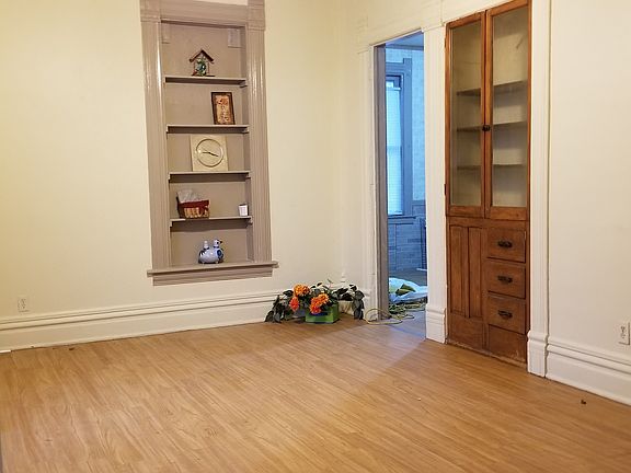 FUL FOrmal dining romm with built in cabinets and decorator shelves
