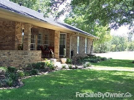 Back View
						:
						Landscaping with beds lined in river rock. Beautiful San Augustine grass.