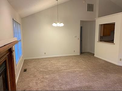 Living Room and Dining Room- Doorway to Master Bedroom. Half wall is Kitchen.