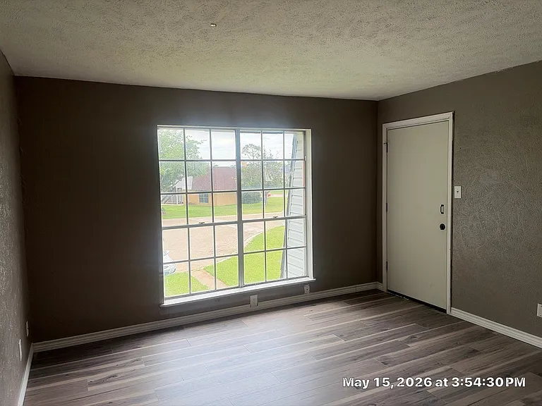 Living room and front door to stairwell.