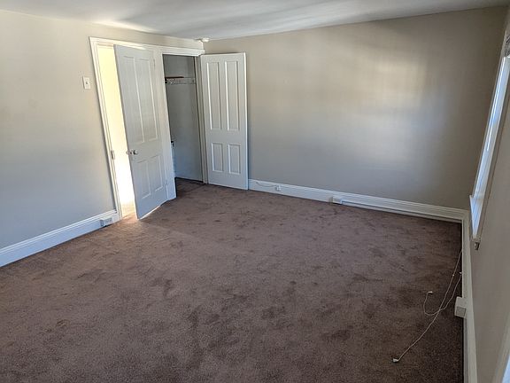 3rd floor master bedroom, view of entry door and closet door (street-facing windows to the right).