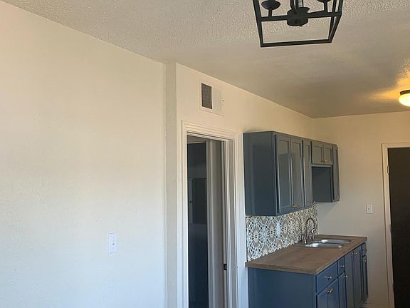 Modern light fixtures and bright open living room